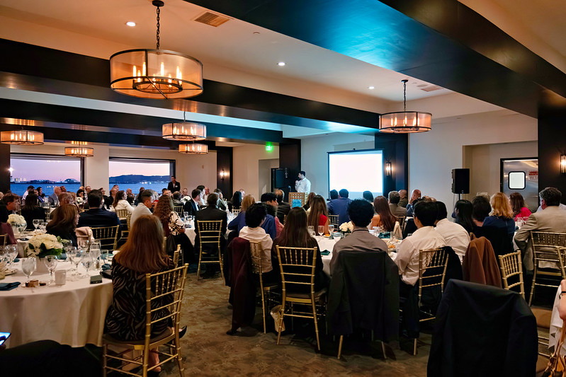 Attendees listening to a speaker during the 2025 Invest in Success event at Tom Ham's Lighthouse.