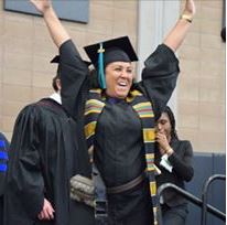 Image of an excited graduate on stage