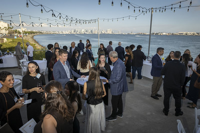 Attendees mingling on an outdoor patio at Tom Ham's Lighthouse.