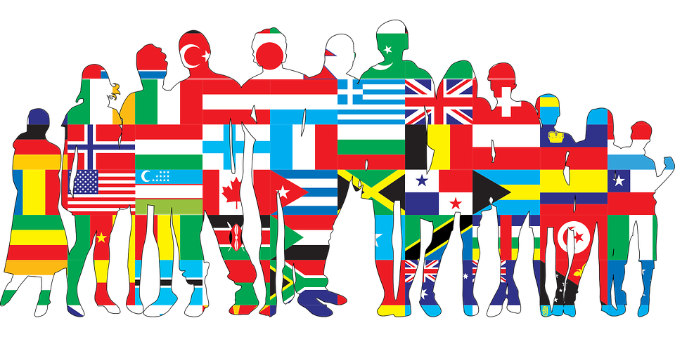 Silhouettes of diverse people filled with various world flags, symbolizing global unity.