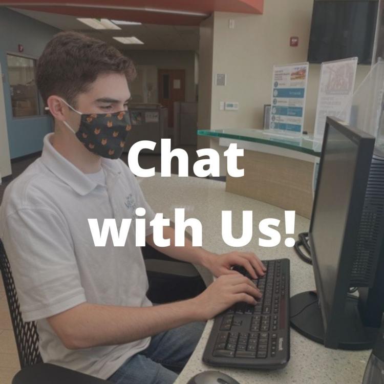student on a computer typing, tilted "chat with us"