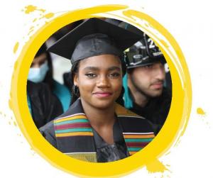 An image of an African American student at her college graduation. Other students can be seen in the background, including one wearing a firefighter's helmet. The image is encircled by a round border resembling paint.