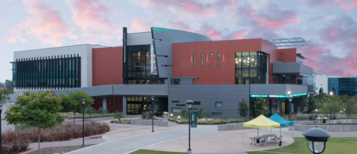 The K1 Student Services building at dusk, with pink clouds in the sky