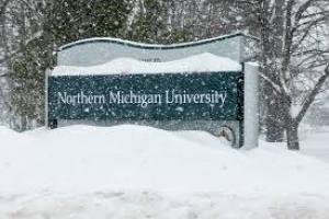 Northern Michigan University sign covered in snow