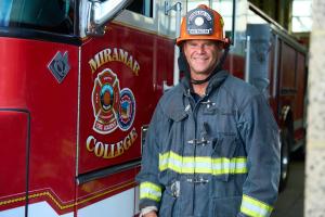 Darren Hall in Fire Uniform next to firetruck