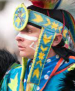 An image of a man in traditional Native American ceremonial dress.